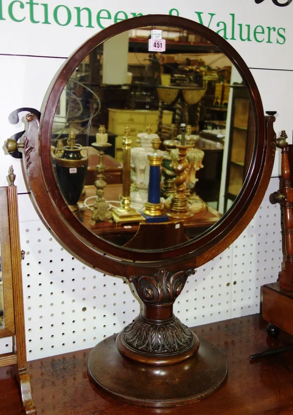 A Victorian mahogany carved circular dressing mirror on a pedestal base, 61cm.