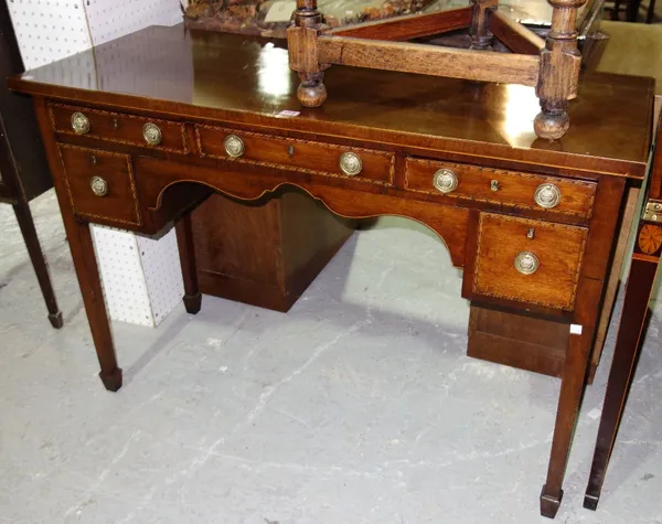 An Edwardian mahogany and satinwood feather banded rectangular dressing table, with five drawers about the knee, 117cm.