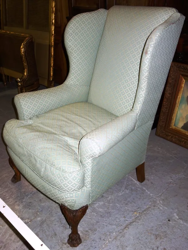 A George III style wingback armchair on cabriole legs.