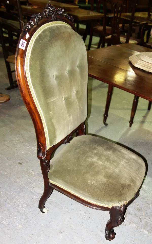 A Victorian floral carved nursing chair with buttoned back.
