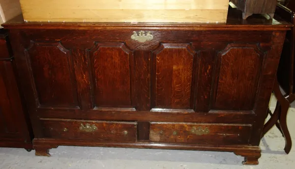 An 18th century oak mule chest, with shaped four panel front over a pair of drawers on ogee bracket feet, 140cm wide.