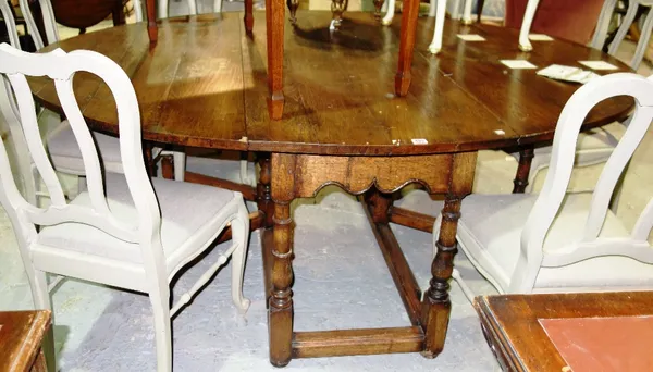 A large 17th century style double gateleg drop flap table, on baluster turned supports, 168cm x 199cm (flaps up).