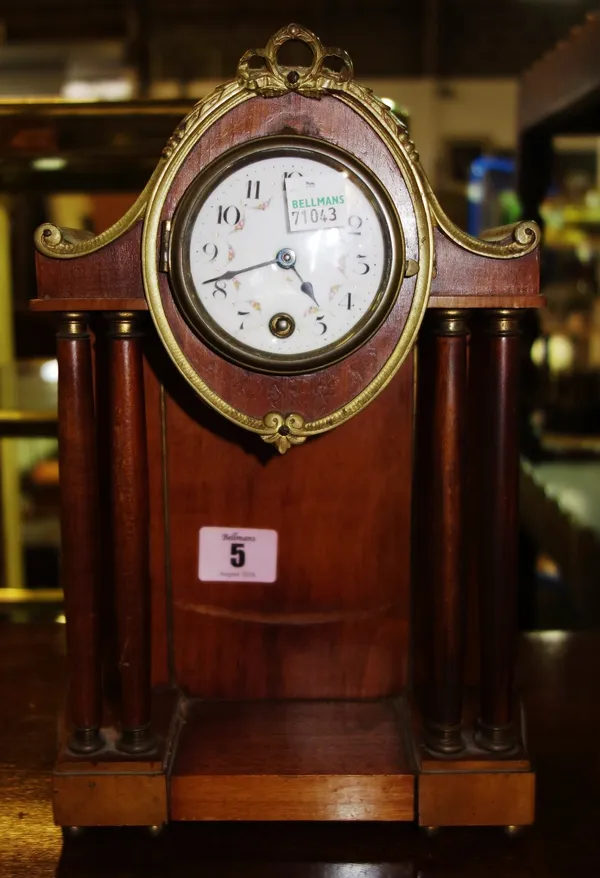 A 19th century mahogany mantel clock with enamelled dial and gilt metal mounts.