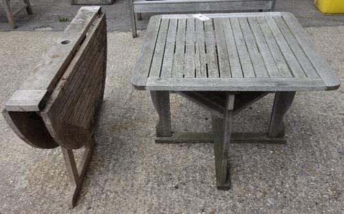 A circular teak table and a square teak table.