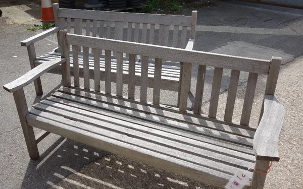 A pair of similar teak garden benches.