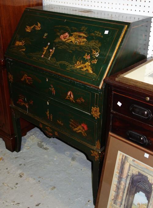 An early 20th century green lacquer chinoiserie decorated bureau, the fall enclosing a fitted interior, over two long drawers, on sabre supports, 76cm