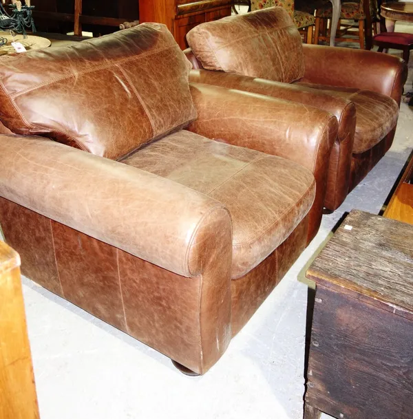 A pair of 20th century brown leather upholstered armchairs. (2)