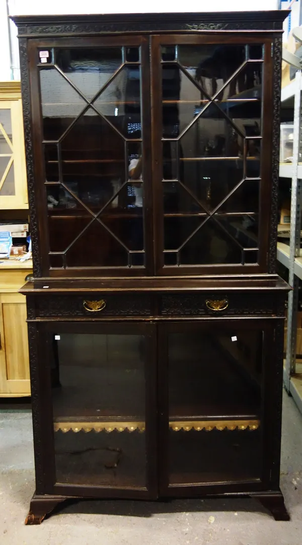 A mahogany glazed bookcase cabinet with blind fret decoration.