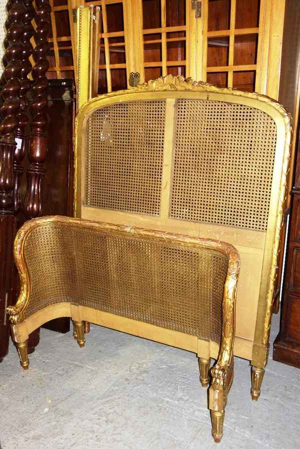 A Louis XVI style giltwood caned single bed.  48