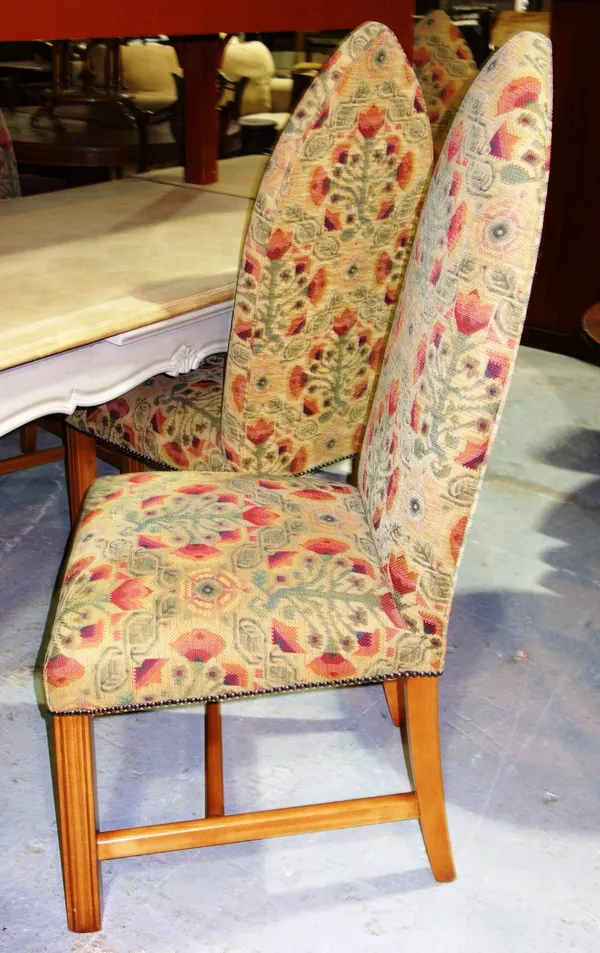 A set of six upholstered dining chairs with Gothic arched backs. (6)