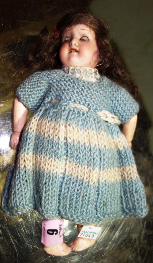 A small early 20th century German bisque head doll.