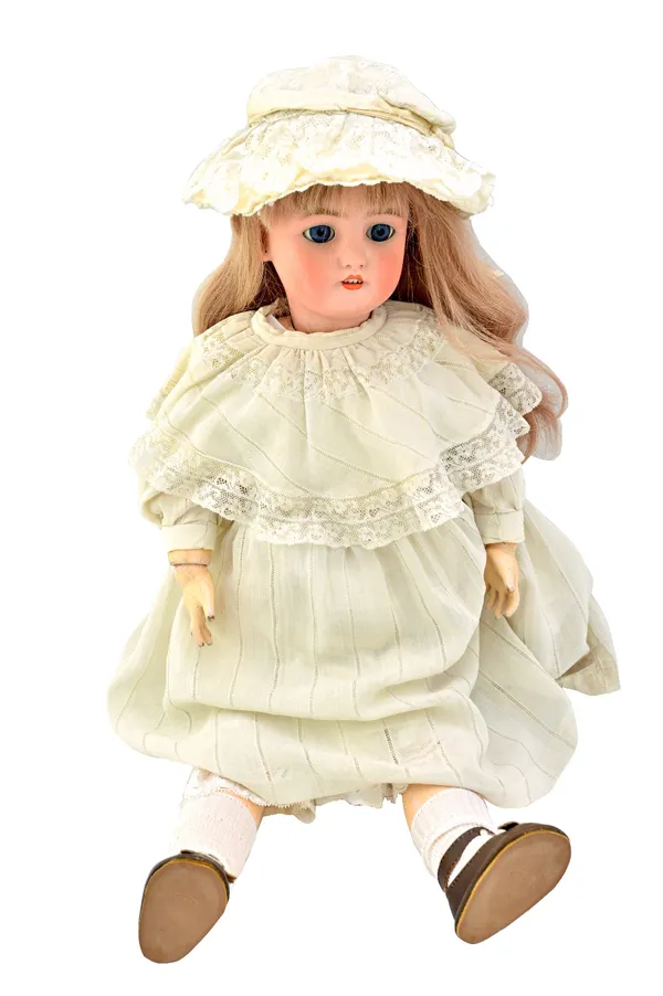 A Simon & Halbig bisque head doll, circa 1900, mould number 10, with sleep eyes and jointed composite limbs, 62cm high.  Illustrated