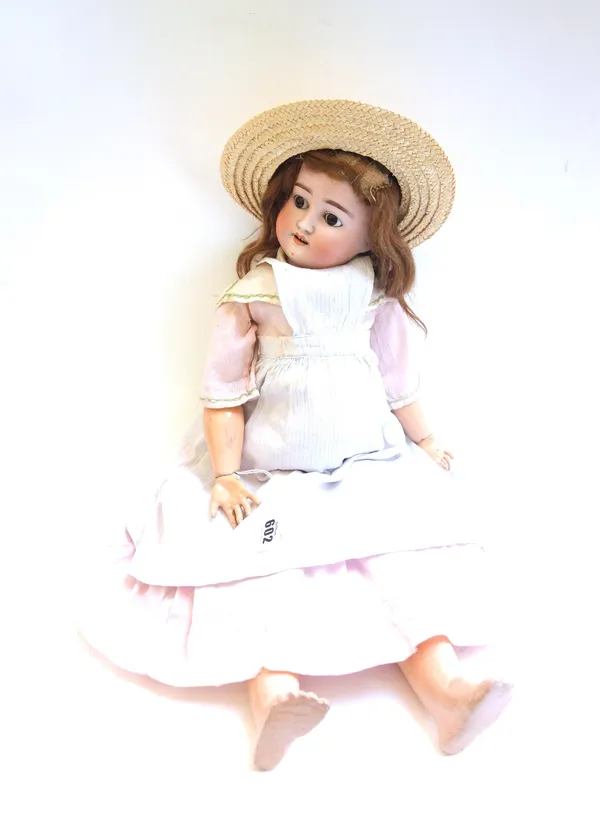 A Simon and Halbig bisque head child doll, circa 1900, mould number 1909, with sleep eyes, open mouth and jointed composite limbs, 55cm.