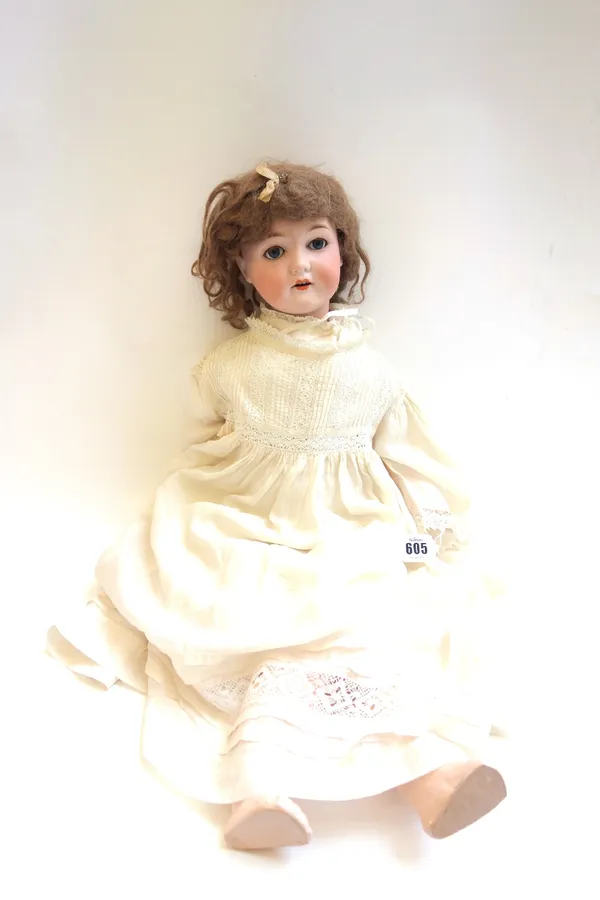 A C.M Bergmann & Waltershausen bisque head doll, Germany 1916-6, with brown wig, sleep eyes, open mouth and composite jointed body, 63cm high.