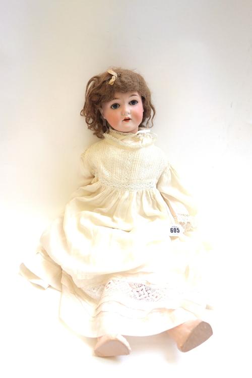 A C.M Bergmann & Waltershausen bisque head doll, Germany 1916-6, with brown wig, sleep eyes, open mouth and composite jointed body, 63cm high.