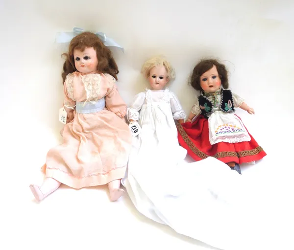 An Armand Marseille bisque head doll, early 20th century, no.390, 28cm high, and two further composite dolls. (3)