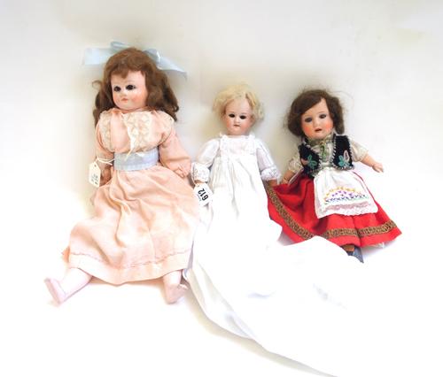 An Armand Marseille bisque head doll, early 20th century, no.390, 28cm high, and two further composite dolls. (3)