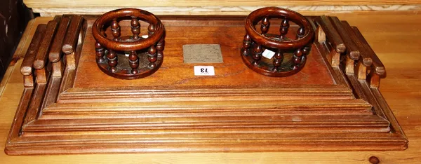 A group of four graduated wooden twin handled trays and a pair of wooden coasters.