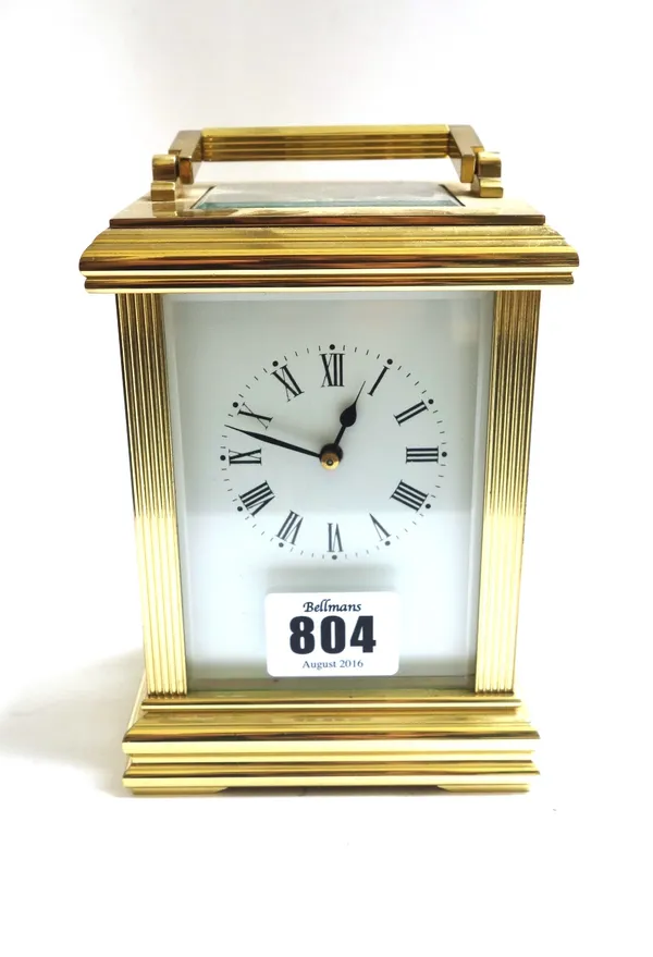 A gilt brass cased carriage clock, late 20th century, the white enamel dial flanked by reeded supports, on a plinth base, with platform escapement and
