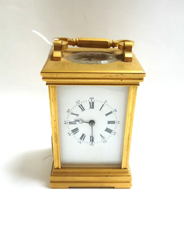 A gilt brass cased carriage clock, 20th century, the white enamel dial detailed with Roman numerals, with two train movement, on a plinth base, 12cm h