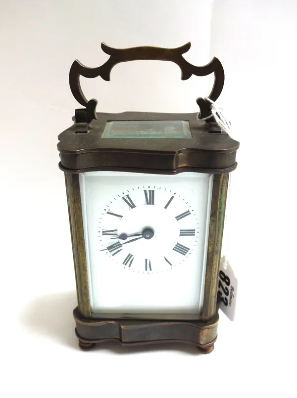 A brass cased carriage clock, late 19th century, with shaped case, white enamel dial and a single train movement on four circular feet, 11.5cm high.