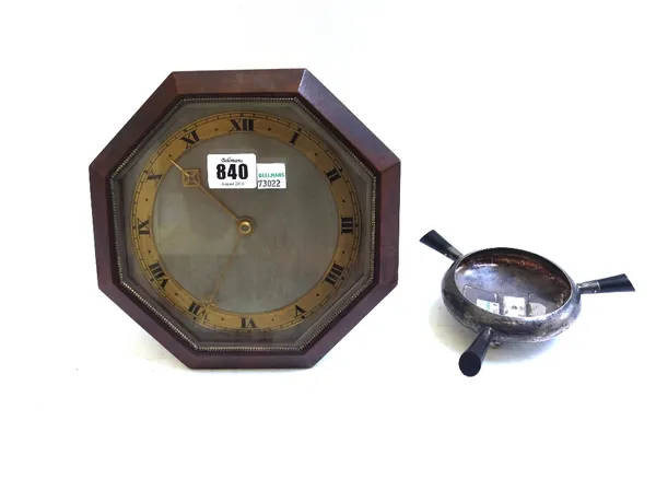 A 1930's strut clock, with silvered dial, pierced and engraved gilt hands and Roman chapter ring, with a walnut octagonal case, barrel movement with l