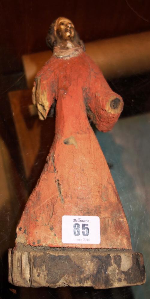 A 17th century and late polychrome decorated figure of a saint, possibly Jesus with gesso head and later pine body, lacking arms.