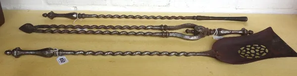 A set of three steel fire irons, 19th century, with hexagonal baluster handles and wrythen twist shafts, the shovel 77cm long. (3)