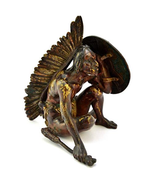 Franz Bergman (1898-1977); an Austrian cold painted model of a North American Indian, modelled crouched with a shield, with impressed marks and number