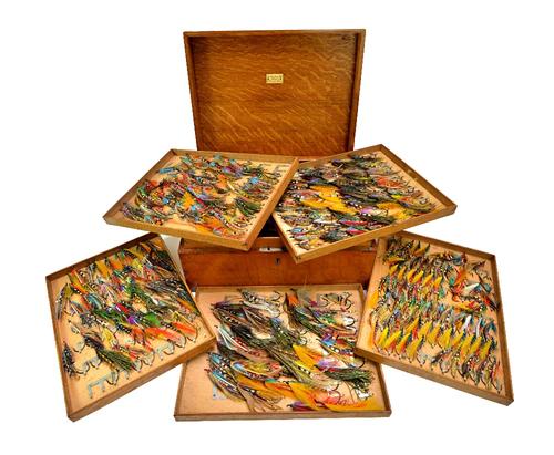 C. Farlow & Co; an early 20th century fly reservoir, the oak box with hinged lid opening to reveal six lift out trays, containing approximately 327 fu