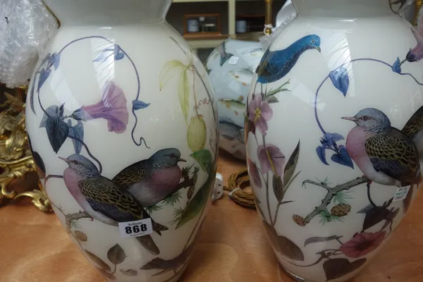 A pair of decalcomania glass table lamps, modern, each decorated with wild birds against an off white ground, 37cm high excluding fitments. (2)