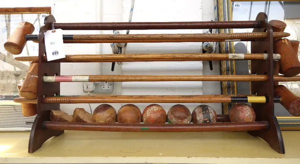 A Jaques croquet set, early 20th century, comprising; eight mallets with turned oak handles, the head stamped 'Jaques London', 95cm long, and seven wo
