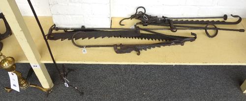 A collection of wrought iron implements, to include four 18th century pot hooks, a late 18th century iron steelyard balance and a late 18th/early 19th