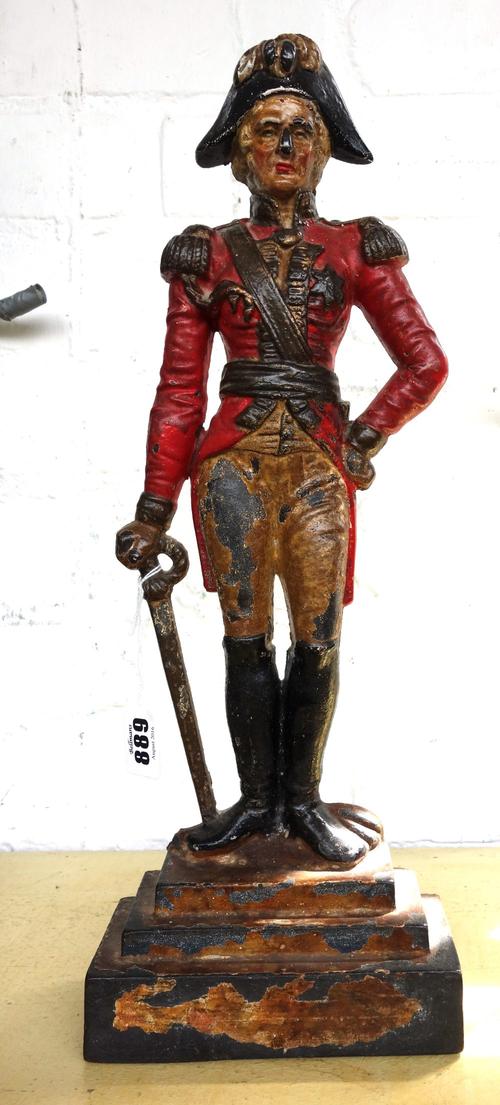 A Victorian polychrome painted cast iron flat back door stop modelled as an army officer, on a stepped rectangular base, 41.5cm high.