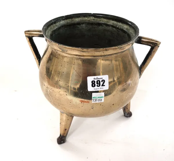 A two handled bronze cauldron on three feet, probably 17th century, 20cm high, and a brass bowl with indistinct decoration to the rim, 39.5cm diameter