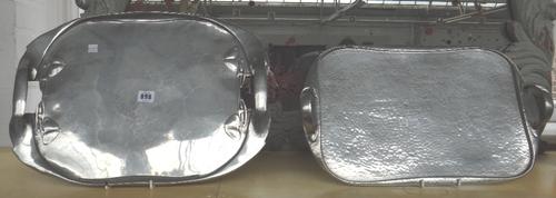 Two Tudric pewter trays, circa 1910, one decorated with a stylised leaf motif to the border, 48.5cm wide, and the other with a planished top surface,
