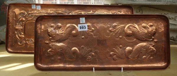 Two Newlyn Arts and Crafts copper trays, circa 1900, of rectangular form, both embossed in relief with four fish swimming amid bubbles and aquatic fol