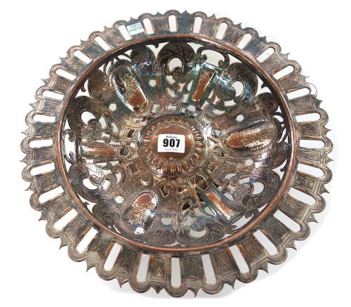 Duchess of Sutherland's Cripples Guild; a silvered copper dish, early 20th century, of round form with undulating borders, the body pierced with a des