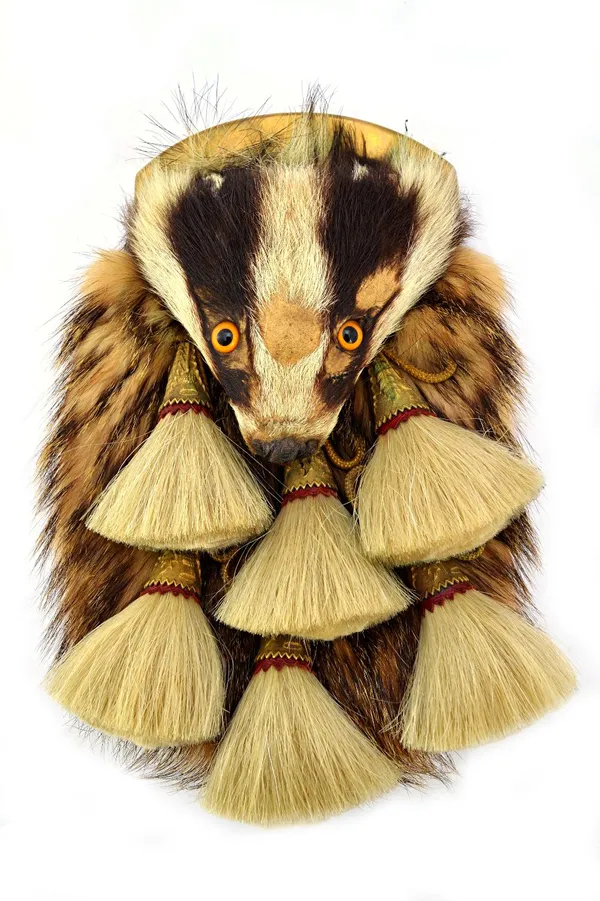 A badger head sporran of the Argyll and Sutherland Highlanders, the head with glass eyes, the badger hair body with six white horse hair tassels, gold