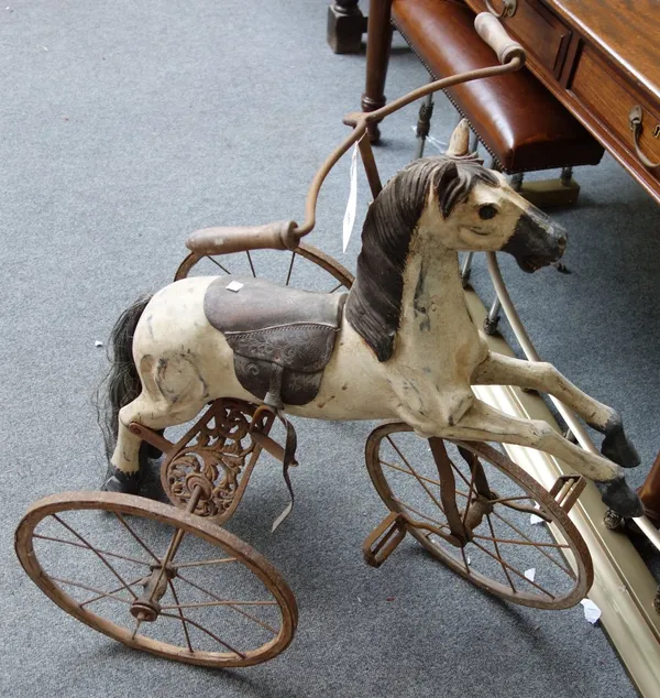 A reproduction velocipede or child's horse tricycle, late 20th century, of polychrome painted wood and wrought iron, 82cm high.
