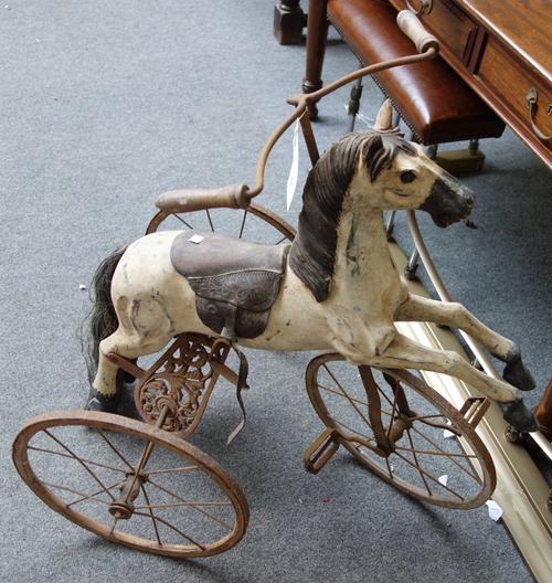 A reproduction velocipede or child's horse tricycle, late 20th century, of polychrome painted wood and wrought iron, 82cm high.