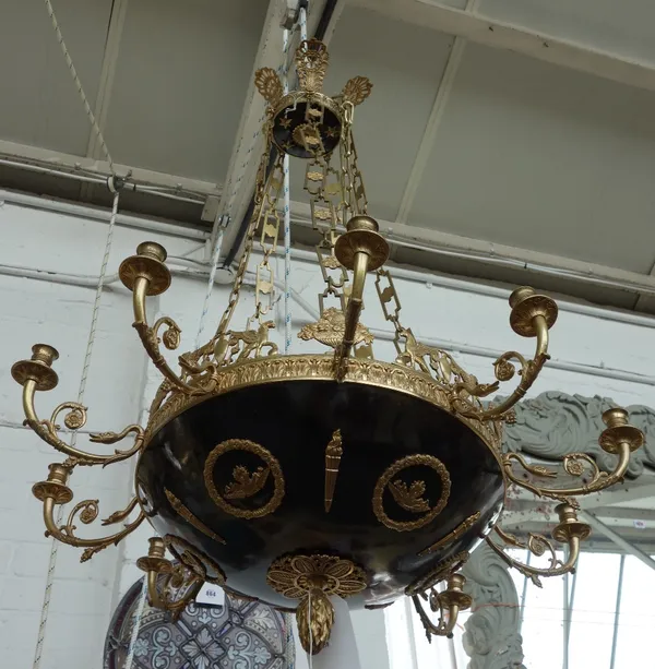 An Empire style gilt and patinated brass ten branch chandelier, 20th century, the circular domed bowl with winged griffin and foliate embellishments i