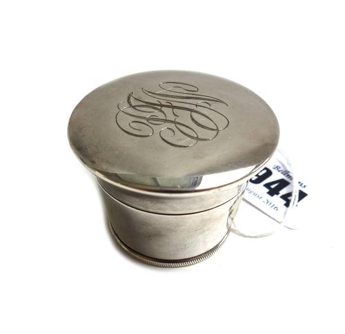 A white metal nutmeg grater, 20th century, of circular tapering form, with screw caps to either end and engraved monogram to the top, stamped 'ABC' to