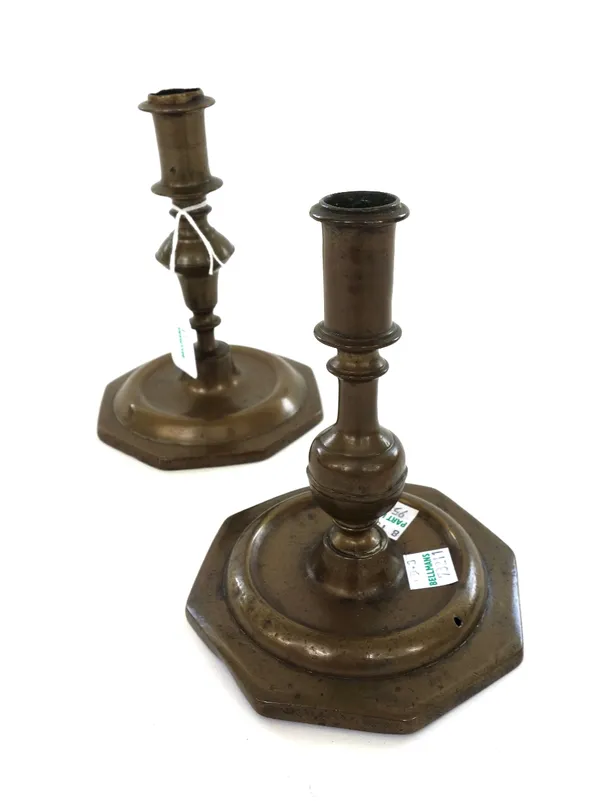 Two similar 18th century bell metal candlesticks, 14.5cm high, a further pair of 18th century bell metal candlesticks on octagonal bases, 17cm high an
