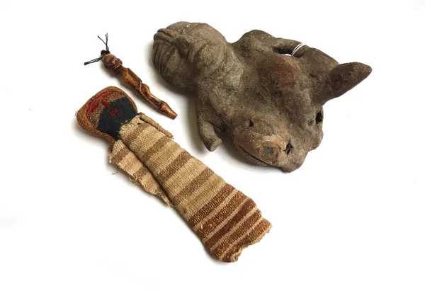 An Incan prayer doll, a carved bone figure, 9.5cm long, and an African pottery fertility figure, 18cm long. (3)