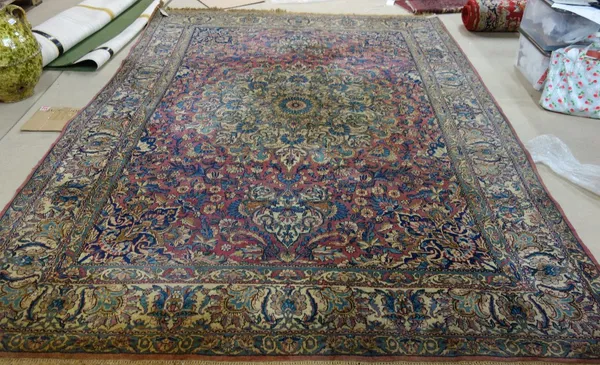 A Kerman carpet, Persian, the pink field with a bold ivory medallion, matching spandrels, all with bold floral sprays, an ivory palmette and carnation