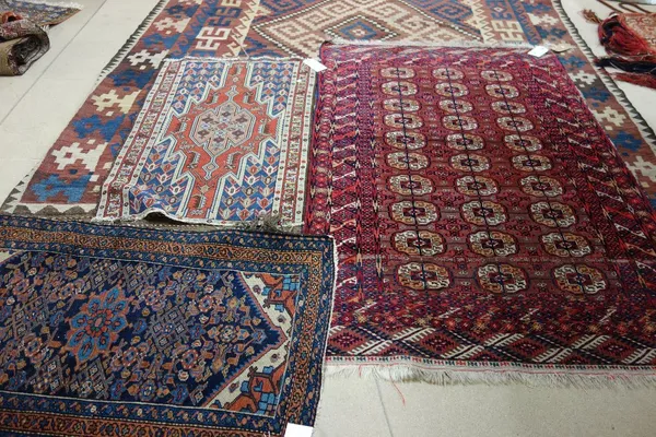 A Tekke Turkman rug, the madder field with three columns of ten guls, supporting crosses, a diamond border, skirt ends, 185cm x 120cm, together with a