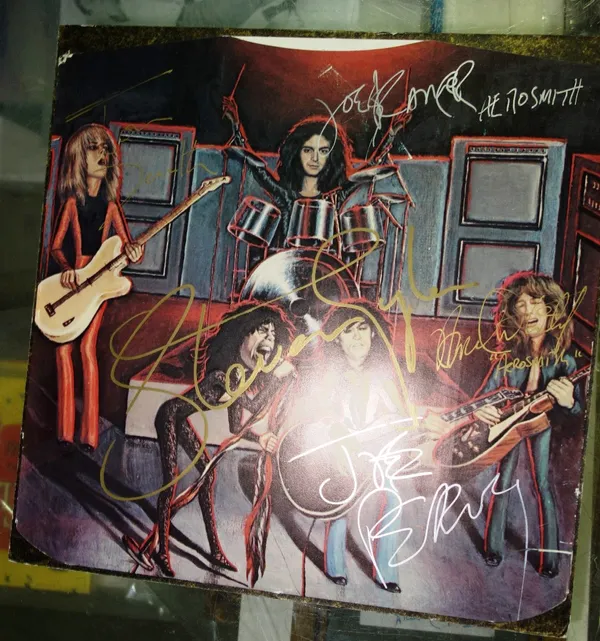 An Aerosmith album cover with signatures. All potential purchasers should satisfy themselves with authenticity of signatures.