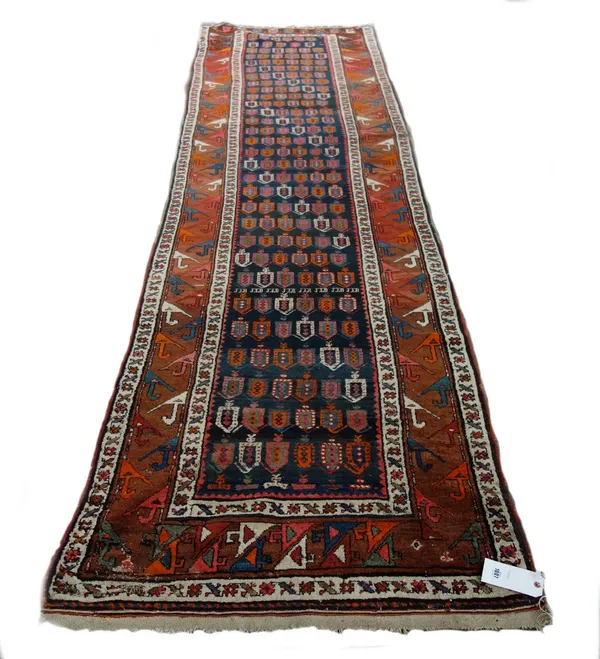 A Kazak runner, Caucasian, the dark blue field with repeating boteh design, in stylised prancing animal border, 400 x 101cm. Property from the estates