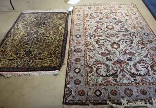 A fine part silk Esfahan rug, Persian the ivory field with two palmettes and surrounded by delicate flowering trees and birds, 137cm x 105cm, some dam